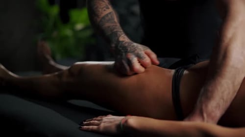 Woman Relaxing While Receiving Leg Massage