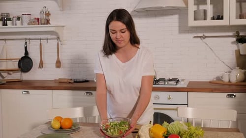 Young Woman Prepares Healthy Salad in Kitchen