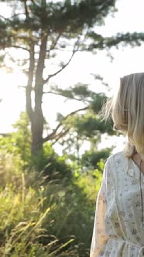 Happy Woman Walking in the Park Dream Portrait at Sunset Relaxing Alone in Nature Vertical Video