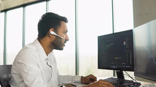 Side View of Smart Indian Crypto Trader Investor Analyst Broker Using Pc Analyzing Digital