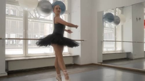 Elegant Woman Performs Ballet in Dance Studio