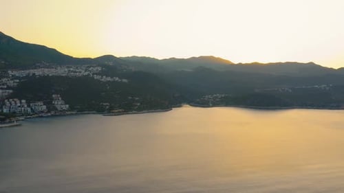 Beautiful Seascape with Mountains and Orange Sunset Sky