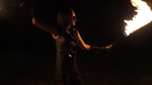 Woman Performing Fire Dance at Night