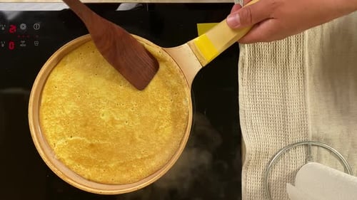 Pancake Cooking in a Pan on Stove