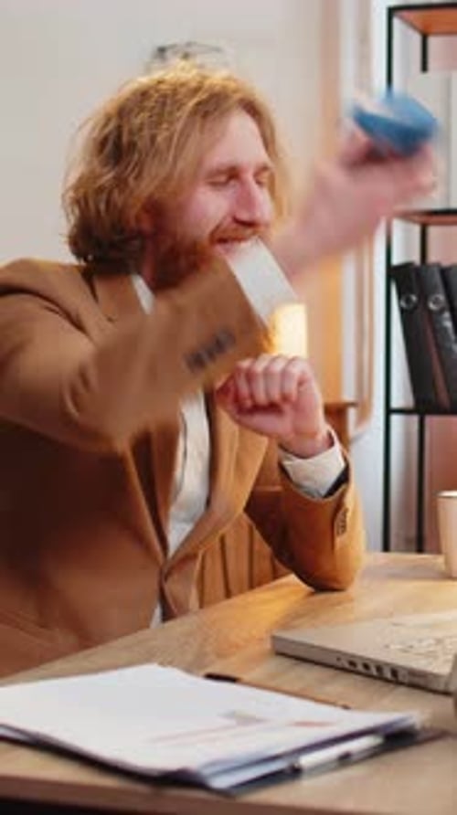 Happy Business Office Man Wears Festive Birthday Hat Hold Cupcake Makes Wish Blowing Burning Candle