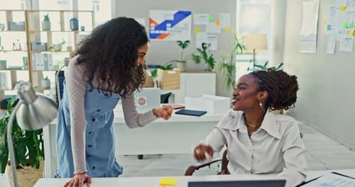 Businesswomen Fist Bumping and Talking at the Office