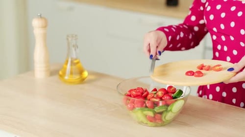 Woman Prepares Healthy Salad in Bright Kitchen