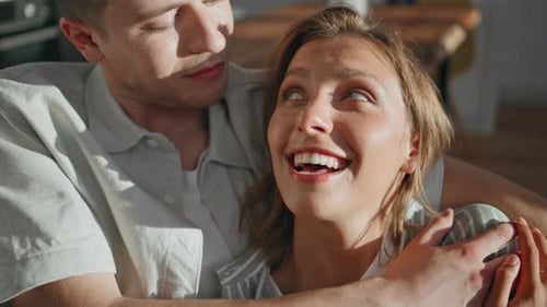 Loving Couple Embracing Affectionately in Bright Home