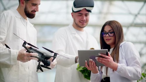 Scientists with Drone and VR Headsets in Greenhouse