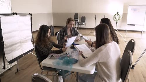 High School Drama Students Rehearsing Script at Classroom Table Actor