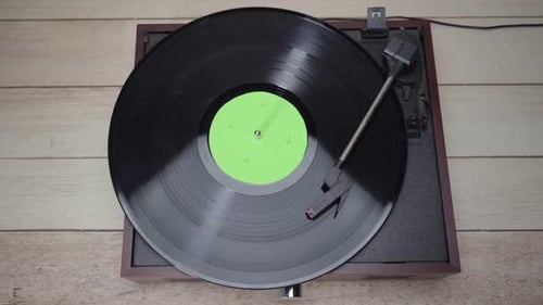 Top view Turning on and playing a Retro vinyl record playing spining,with green screen croma