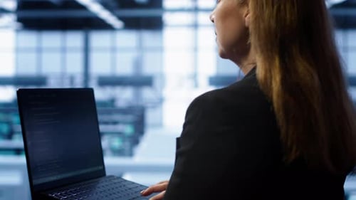 Technician Doing Checkup Inputting Data on Laptop of Needed Server Hub Fixes