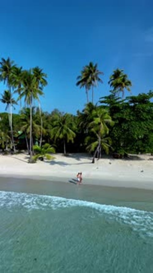 Stunning Tropical Beach on Koh Kood Island Thailand with Couples Enjoying the Serene Shoreline