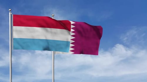 Luxembourg and Qatar Flags Waving Realistically in Blue Sky