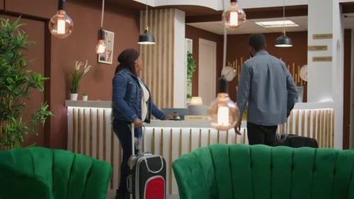 Hotel Guests Checking in at Front Reception Desk