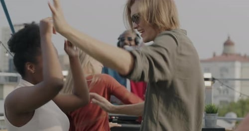 Young Adults Dancing and Celebrating on Rooftop