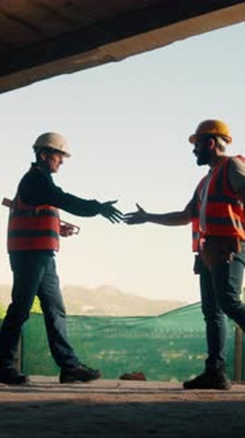 Teamwork, contractor and worker with handshake at construction site, labor agreement