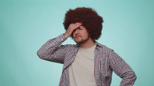 Adult Man Rubbing Temples Experiencing Headache