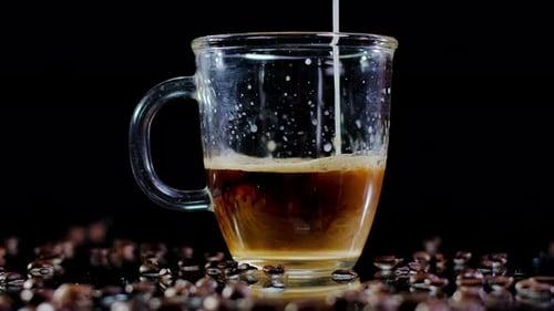 Milk Being Poured Into Glass Coffee Mug