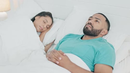 Worried Man Lying Awake in Bed