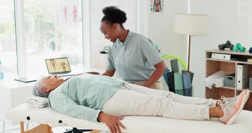 Therapist Assists Senior Woman with Arm Exercise
