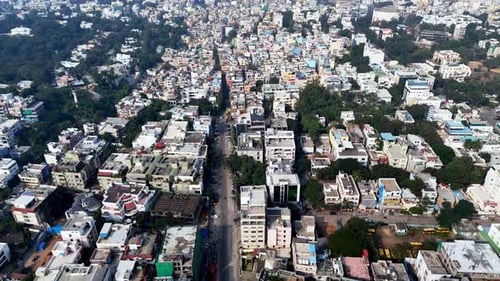 Drone shot capturing the cityscape of Hyderabad with commercial complexes, residential areas, and