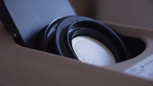 Person Making Coffee With a Pod Machine