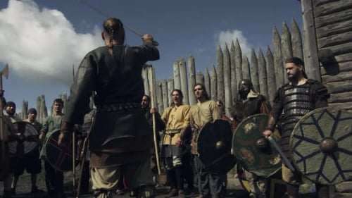 Group of Men in Costume Holding Weapons Outdoors