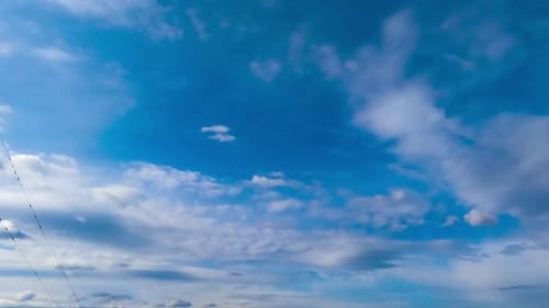 Light clouds transforming into heavy grey dramatic cloudscape. Low angle view. Timelapse.