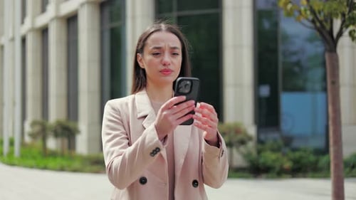 Woman Outdoors Frustrated With Smartphone