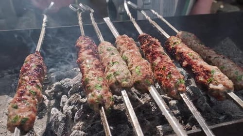 BBQ on skewers. Kebabs are being grilled on the coils