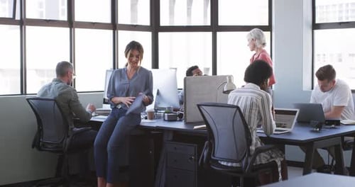 Coworkers, coworking and office with computers, conversation and documents in workplace
