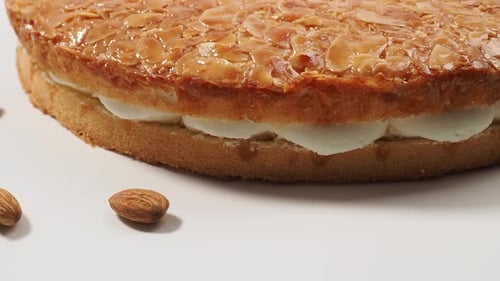 Tasty Almond Layer Cake on White Background