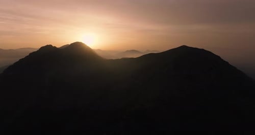Mountain Range Silhouettes at Warm Sunset