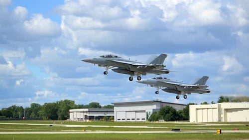 Slow Motion View of Two F18 Fighter Jets Taking Off Into the Bright Sky Showcasing Military Strength