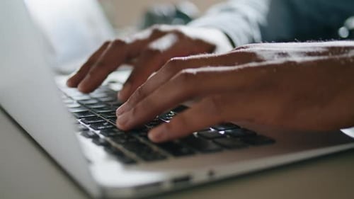 Hands Typing on Laptop Keyboard Close Up