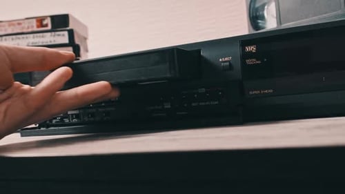 Insert VHS Cassette Into VCR Video Player