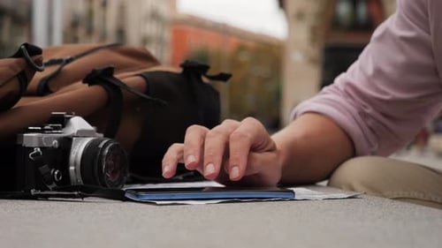 Tourist Using Phone for Navigation in City