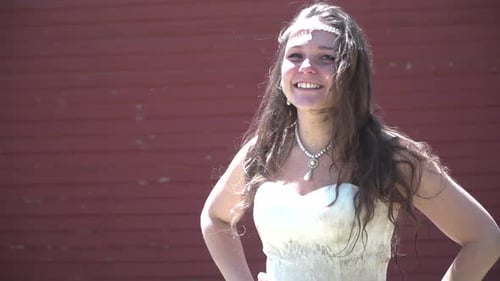Bride in Disheveled Wedding Dress Smiles