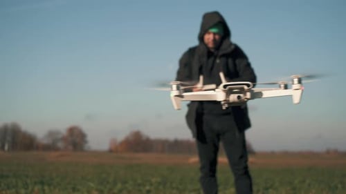 White Drone Flying on Nature Background. Drone Hanging in Air Flying Helicopter Dron Remote Control