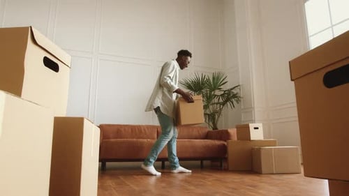 Man unpacking and relaxing in new house