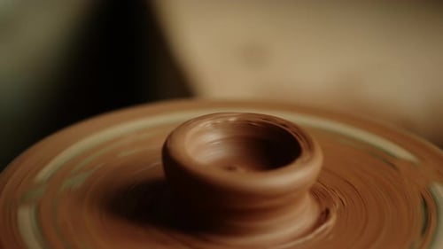 Closeup Wet Clay Spinning on Potters Wheel in Workshop. Unrecognized Artist Starting