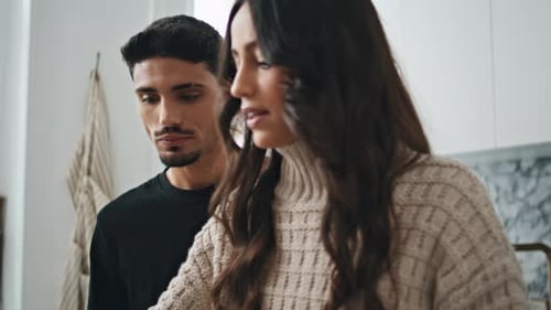 Serious Pair Talking at Kitchen Close Up Gentle Man Looking at Gorgeous Wife