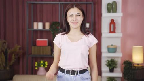 Woman looking at camera cuts by making scissors sign.