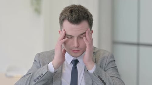 Adult Man Suffering from a Severe Headache