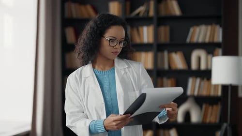 Young Woman Doctor in Hospital Office Serious Medical Student Girl Wearing White Medical Coat Look