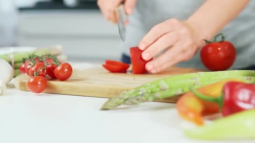 Wash tomatoes mistress puts on cutting wooden board for cutting into salad