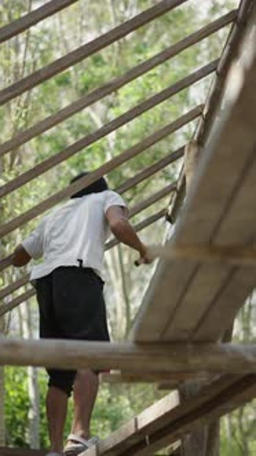 Man Builds Structure Outdoors