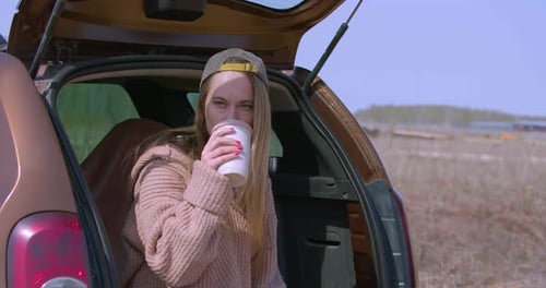 Zoom in of a Coffee Break in the Car Trunk During Lonely Travel