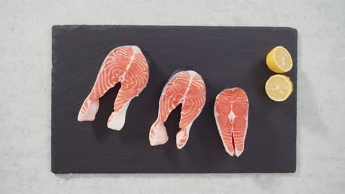 Time Lapse Farmraised Salmon Steaks on a Slate Board